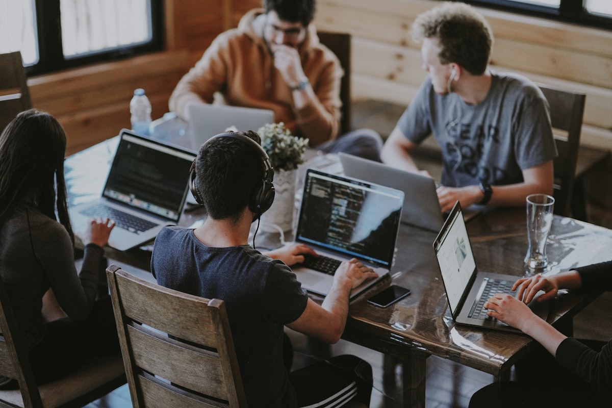 Team collaborating in a glass meeting room